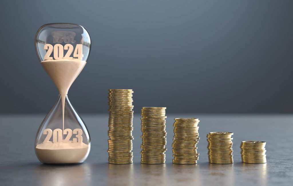 Hourglass with 2023 and 2024 on sand and ascending coin stacks, symbolizing time and financial growth.